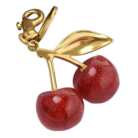 2025 trend cherry bag charm, vibrant red, luxe gold, maximalist style, bag charms must-have, playful chic, handbag upgrade, personalize bag charm, Gen Z favorite, statement accessory, bold and trendy, elevate your style, handbag essential, fashion-forward, mix-and-match vibes, eye-catching design, trendy personalization, shop now, ultimate bag charm, modern elegance, standout piece, perfect gift idea.