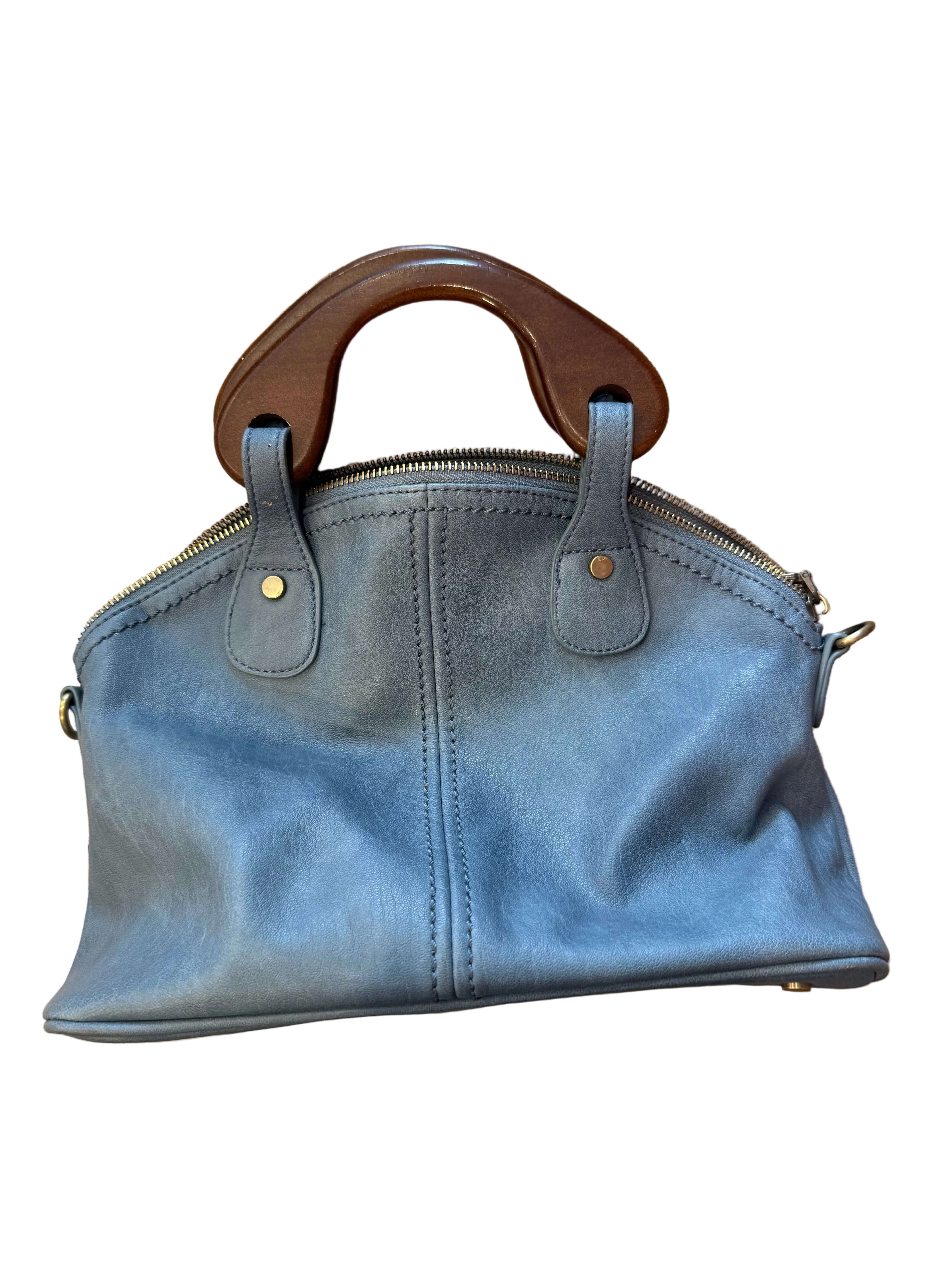 Blue handbag with wooden handle on a wooden surface